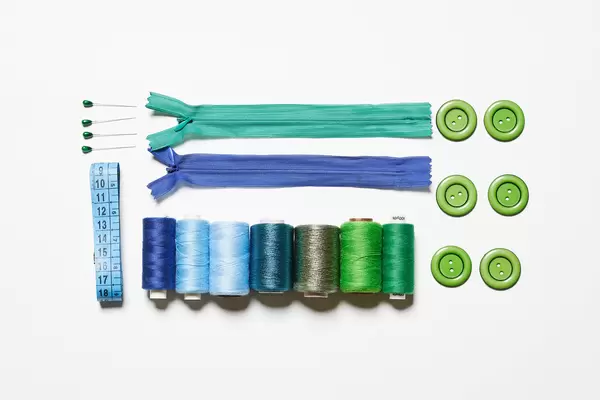 Sewing supplies on white background