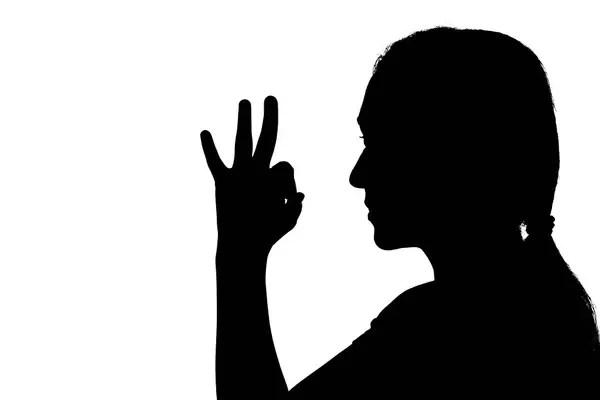 Shadow of a woman showing OK sign hand gesture