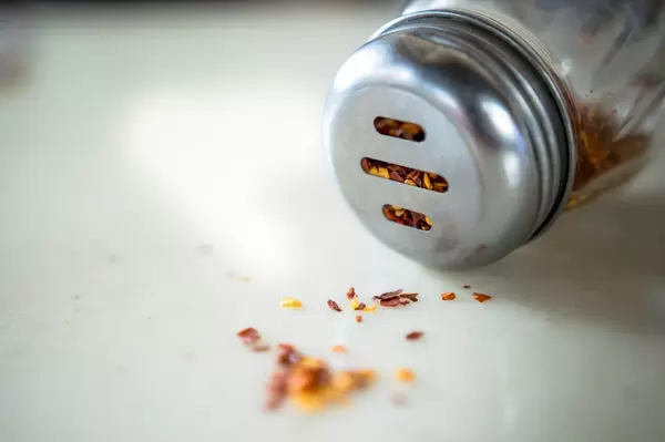 Shaker with dried grounded chili pepper
