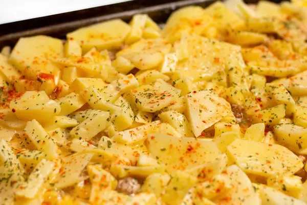 Shallow focus on raw potatoes moussaka ready for baking