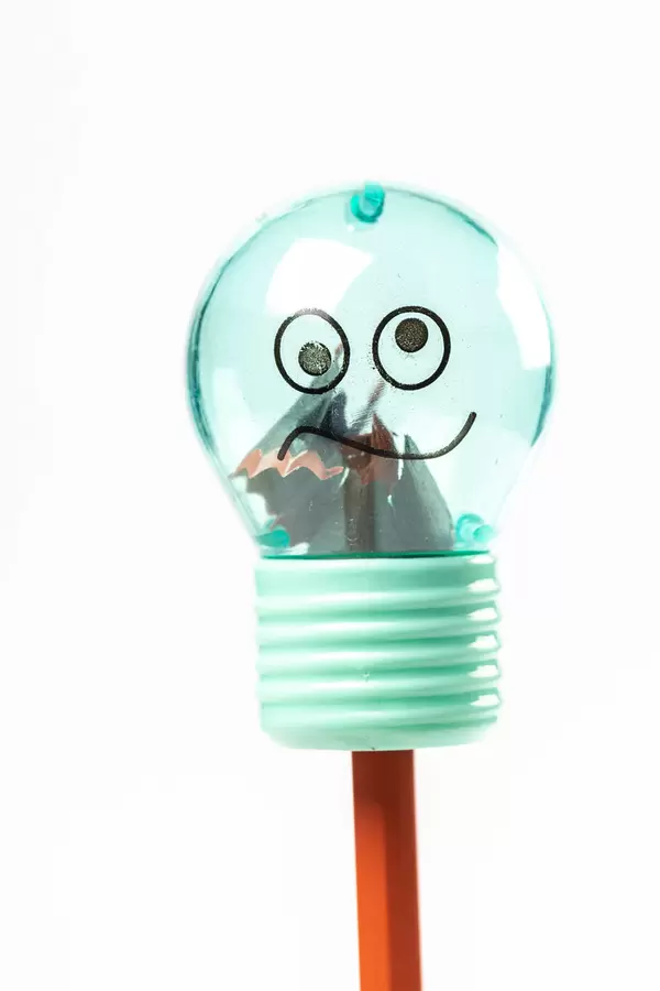 Sharpener in the shape of a light bulb and pencil, close-up