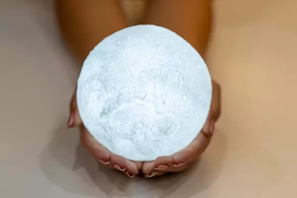 Shining full white moon in women's hands (Flip 2019)