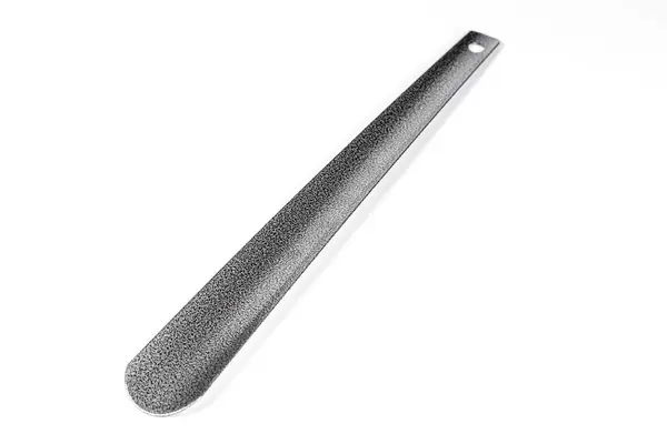 Shoehorn on white background. Black long spoon