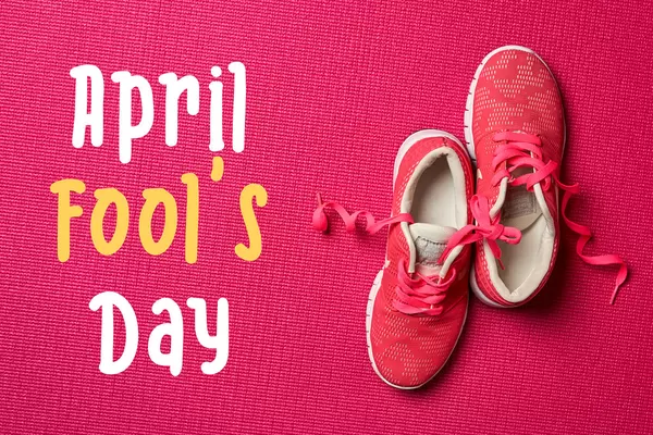 Shoes with tied laces on red color background