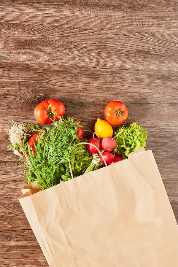 Shopping bag full of fresh vegetables and fruits