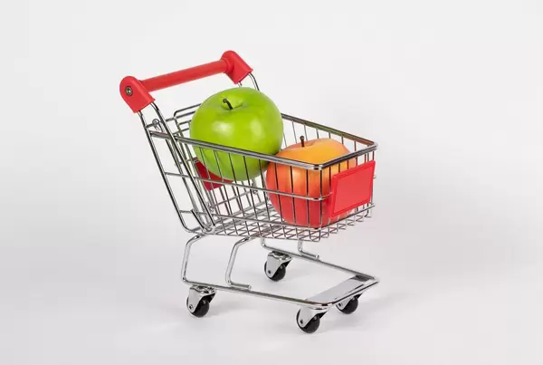 Shopping cart filled with fresh apples