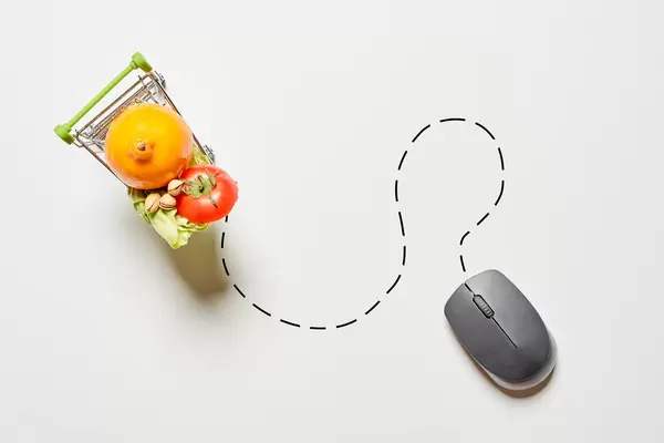 Shopping cart full of groceries with computer mouse