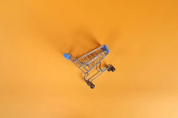 Shopping cart on orange background