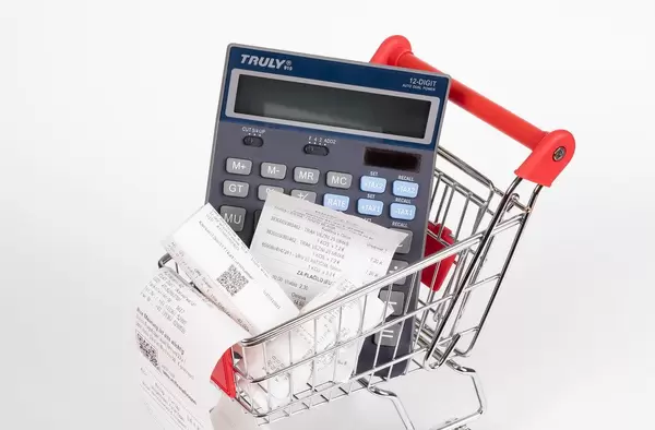 Shopping cart with Receipts and calculator on white background