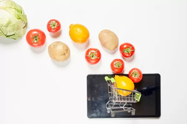 Shopping trolley and fresh organic vegetables