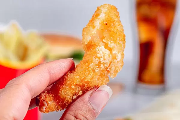Shrimp fried in breadcrumbs in women hand