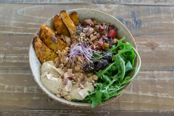 Sicilian Caponata with aubergines, potatoes, rucola salad and hummus