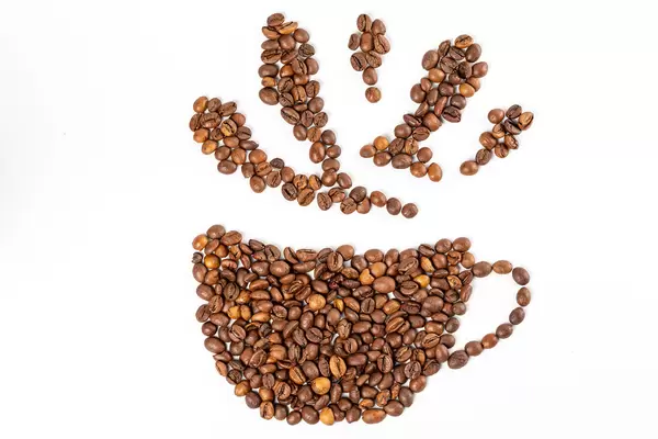 Silhouette mugs of coffee beans on the white background