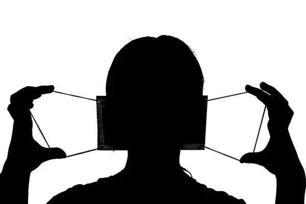 Silhouette of a person wearing medical face mask isolated on white