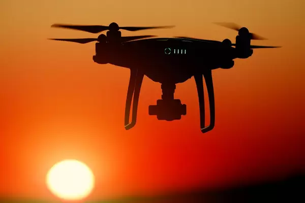 Silhouette of drone at sunset, orange sky (Flip 2019)