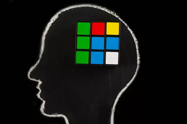 Silhouette of human head with rubik's cube, concept of mind, thinking and ideas