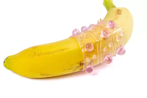 Silicone sleeve for penis on a banana, close-up