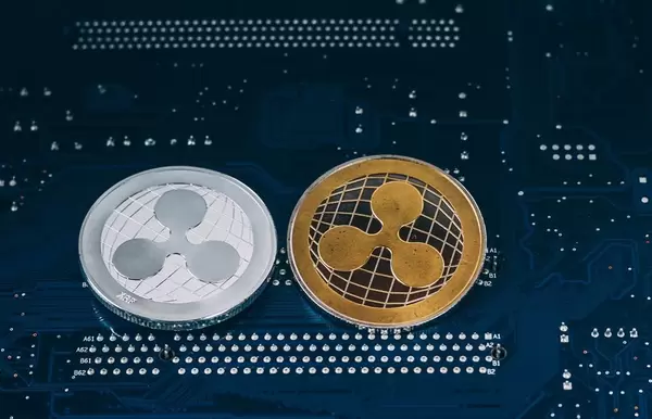 Silver and gold ripple coin on blue background