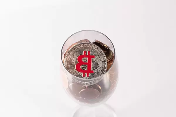 Silver Bitcoin and coins in champagne glass (Flip 2019)