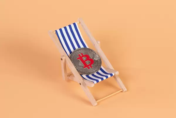 Silver Bitcoin coin lying in a deck chair