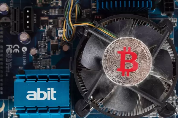 Silver Bitcoin on a computer cooling fan