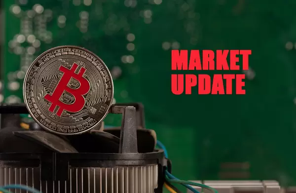 Silver Bitcoin on computer parts with Market Update text