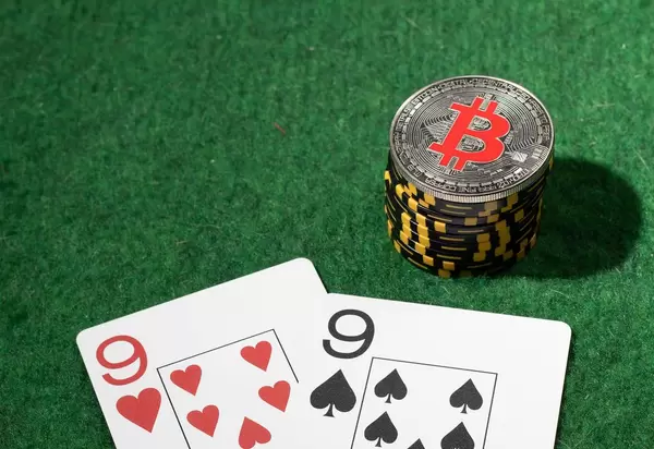 Silver Bitcoin on the poker table with chips