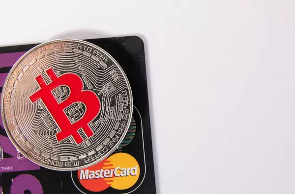 Silver Bitcoin with black credit card