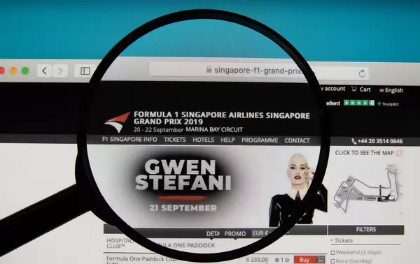Singapore Grand Prix website on a computer screen with a magnifying glass