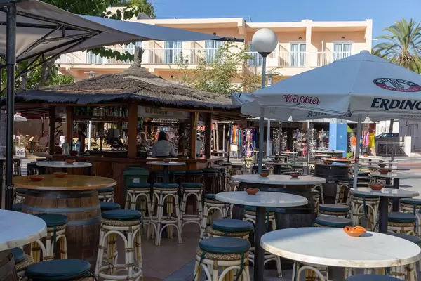 Sitzgelegenheiten und Sonnenschirme an einer Bar auf Mallorca
