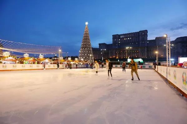 Skate rink at Bucharest Christmas market, The Palace of Parliament on background (Flip 2019)