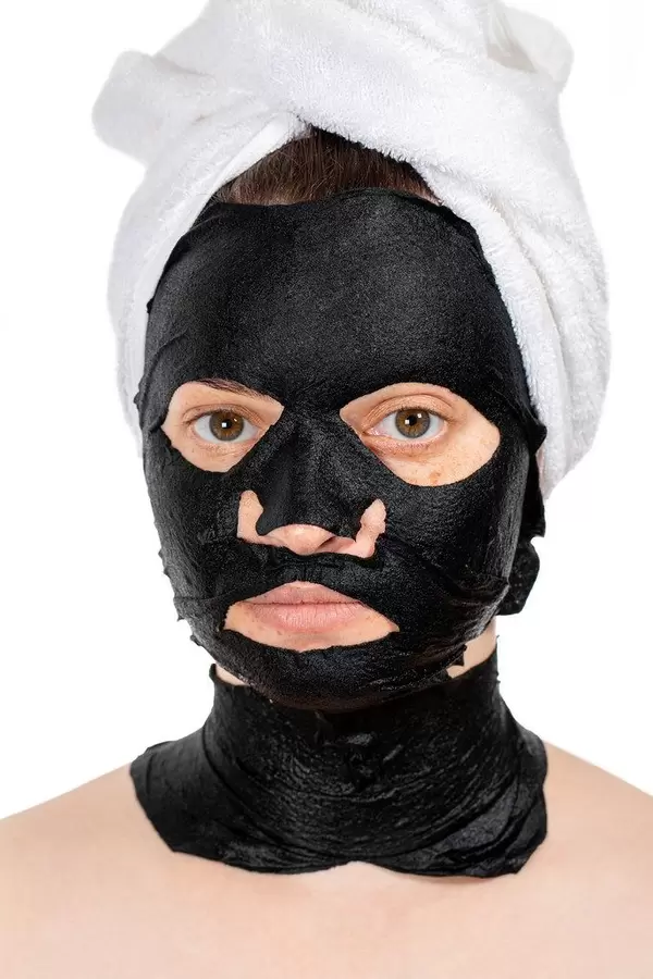 Skin care face concept- black mask on face women