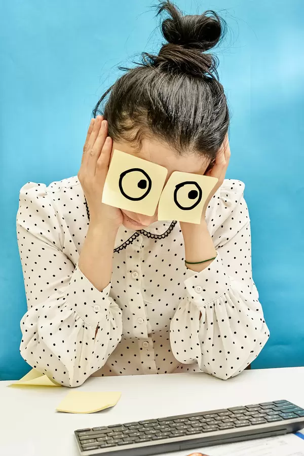 Sleeping at the office. Office worker sleeping during work with drawn eyes on stickers