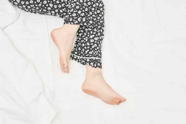 Sleeping female beautiful feet on the bed