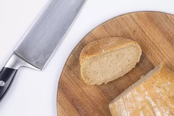 Slice of healthy Bread on the round wooden board