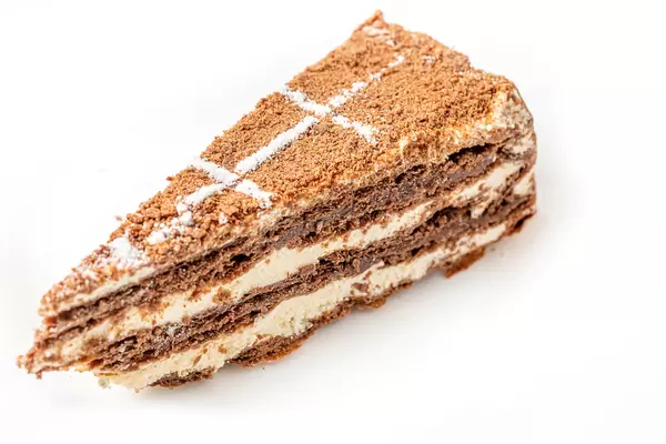 Slice of napoleon chocolate cake on white plate