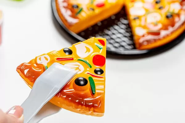 Slice of toy pizza closeup