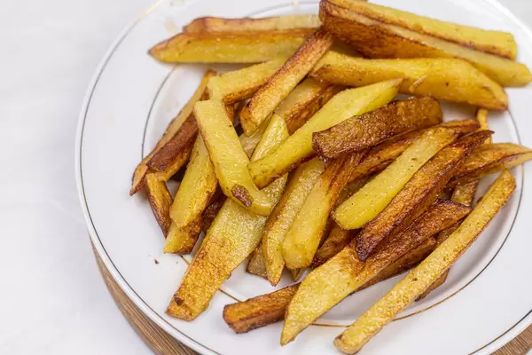 Sliced and fried potatoes served on the plate