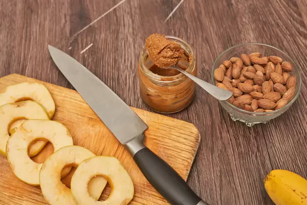 Sliced apple pieces, nuts and peanut paste