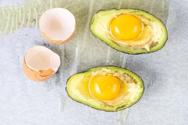Sliced Avocado with raw Eggs ready for baking (Flip 2019)