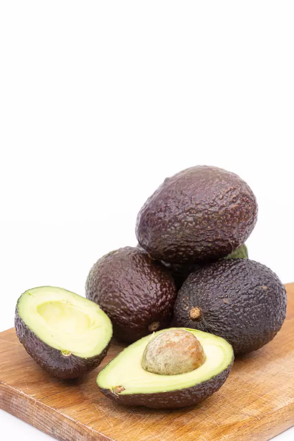 Sliced Avocados on the wooden board with copy space