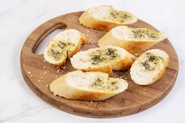 Sliced Baguettes served on the wooden board