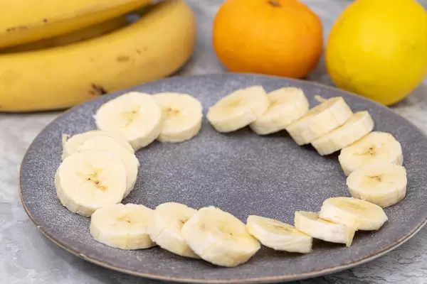Sliced Banana with Orange and Lemon in the background