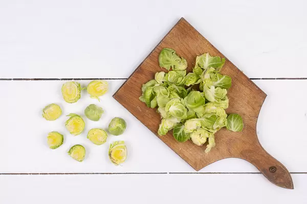 Sliced Brussel Sprouts on the wooden cutting board