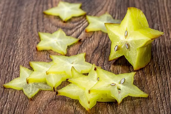 Sliced carambola fruit on wooden background (Flip 2019)