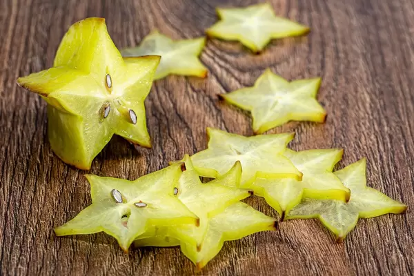 Sliced carambola fruit on wooden background
