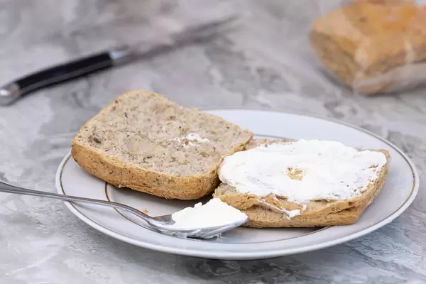 Sliced dark Bread served on the plate with cheese cream