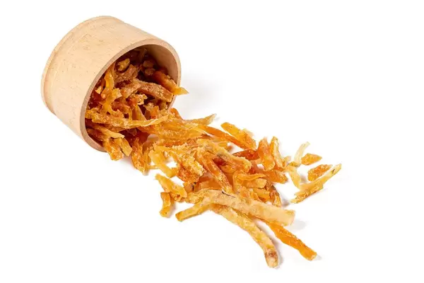 Sliced dried tuna meat on white background with wooden bowl
