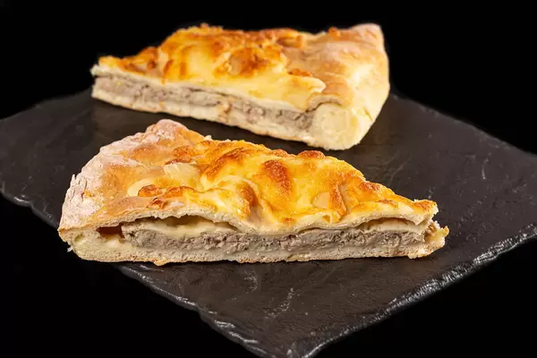 Sliced fresh khachapuri with cheese and minced meat