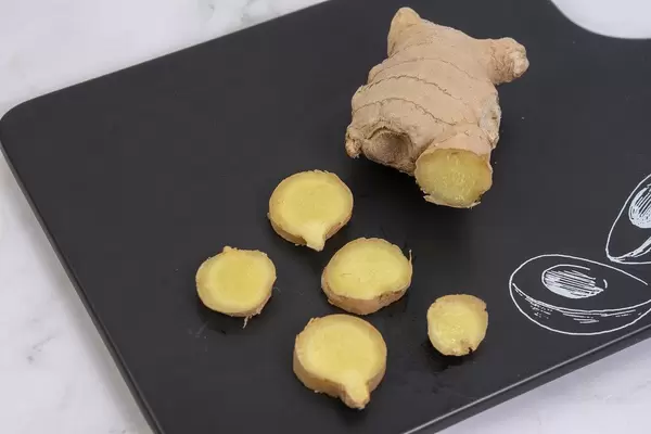 Sliced Ginger on the black tray with Tasty sign